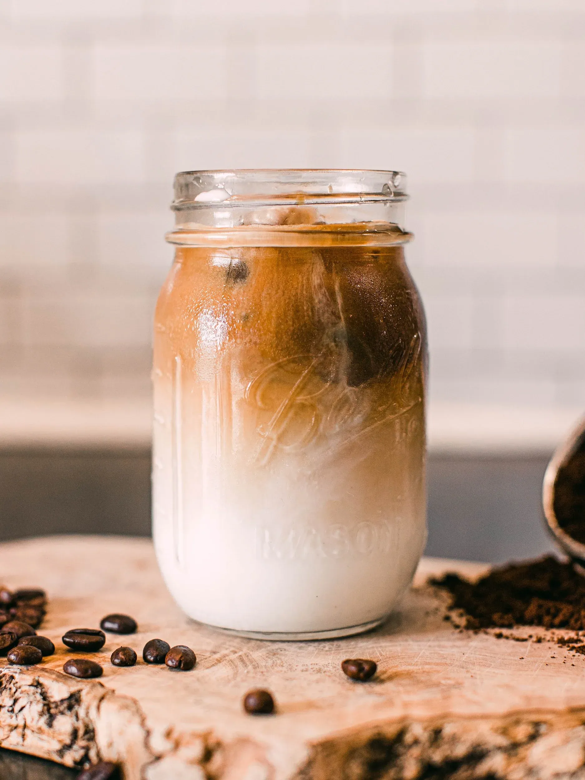 mason jar of coffee layered on top of milk